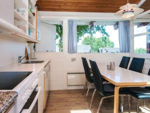 a kitchen with a dining room table and chairs at 6 person holiday home in Aabenraa in Aabenraa