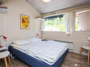 a large bed in a room with a window at 6 person holiday home in Aabenraa in Aabenraa
