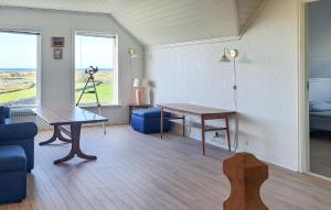 a living room with a table and a couch at 3 Bedroom Stunning Home In Vanse in Borhaug