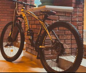 a bike parked next to a brick wall at Kay’s Den Kandy in Peradeniya