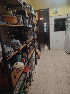 a room with shelves filled with pots and pans at Murillo in Montevideo +11 photos