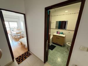 a bathroom with a toilet and a sink and a mirror at Entroncamento & Fátima in Entroncamento +12 photos