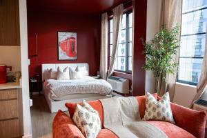 a living room with a bed and a couch at Lux Bronx Apt Rooftop, Pool, Gym, Cinema in Mott Haven