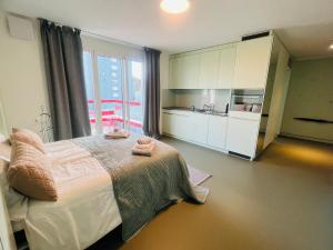 a bedroom with a bed with two towels on it at Modern Living, Luxe Apartment Zurich in Zurich