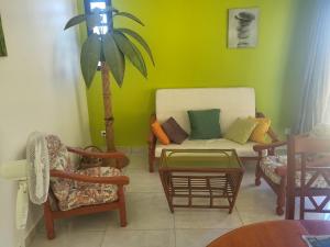 a living room with a couch and two chairs at Chambre indépendante calme pour femmes, en forêt, 1km plage in Deshaies