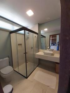 a bathroom with a shower and a toilet and a sink at Villas BobZ Barra grande in Barrinha