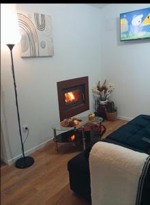 a living room with a couch and a fireplace at O Caminho Azul in Olivenza