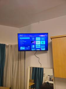 a flat screen tv hanging on a wall at Story Haus apartments in Chester