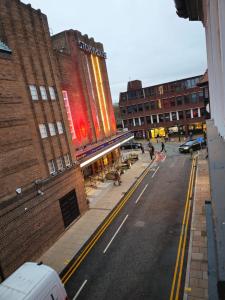 an empty street in a city with buildings at Story Haus apartments in Chester