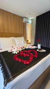 a large bed with a large amount of flowers on it at Widji Garden Villa in Uluwatu
