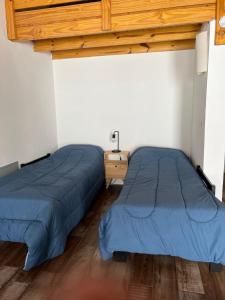 two beds sitting next to each other in a room at Chalten Mountain Loft 8 in El Chalten