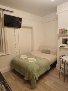 a bedroom with two beds and a flat screen tv at Story Haus apartments in Chester +27 photos