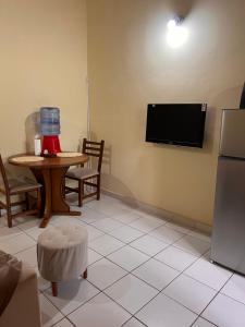 a living room with a table and a tv on the wall at Departamento in Fernando de la Mora