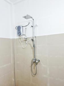 a shower with a shower head in a bathroom at Villa Yoniky - Weligama in Weligama