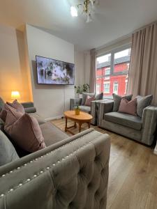 a living room with a couch and a table at Liverpool Rose House Stylish 3 Bed Near Anfield and Goodison Park in Liverpool