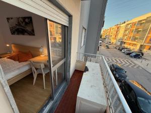 a balcony of a apartment with a bed and a window at Entroncamento & Fátima in Entroncamento
