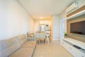 a living room with a couch and a table at Apartamento vista para o mar com 02 dormitórios in Canto Grande