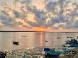 a group of boats in the water at sunset at Mafazy House in Lamu +7 photos