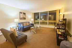 a living room with a couch and a tv at 2BR Downtown apt Amazing View Free Parking & Gym in Saskatoon