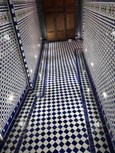 an empty room with a door and a checkered floor at M & S Guest House in Fès
