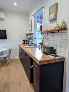 a kitchen with a sink and a counter top at Donnelly's Keep Cottage 
