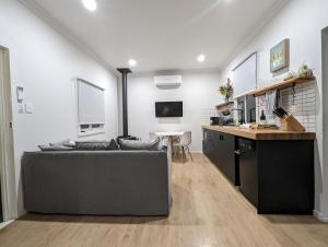 a living room with a couch and a table at Donnelly's Keep Cottage 