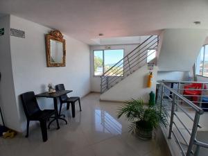 a room with a table and chairs and a staircase at HOTEL LA RUEDA SR in Barbosa