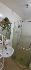 a bathroom with a glass shower and a sink at Cozy 2BR Seawind Near Airport and Samal Island in Davao City