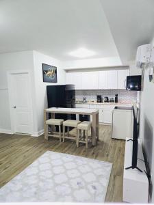a kitchen with white cabinets and a table and chairs at Home away from home in Elizabeth