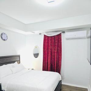 a bedroom with a bed and a red curtain at Home away from home in Elizabeth +11 photos