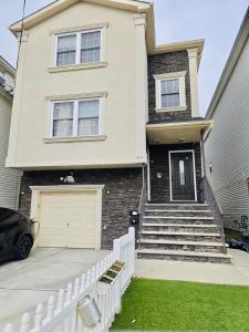 a house with a white fence in front of it at Home away from home in Elizabeth