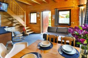 a living room with a table and a couch at Comfortable holiday homes close to the beach in Bobolin