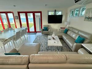 a living room with a couch and a table at Beachfront Spacious Luxury Villa Private Pool in Fortuna