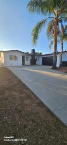 a building with palm trees in front of a street at Lovely Rural Living in Cherry Valley