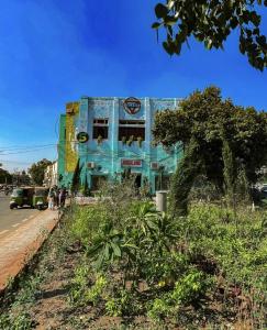 a blue building on the side of a street at YMCA Girls Hostel, Mall Road, Lahore in Lahore