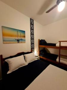 Postel nebo postele na pokoji v ubytování Pousada Pé na Areia Itanhaém