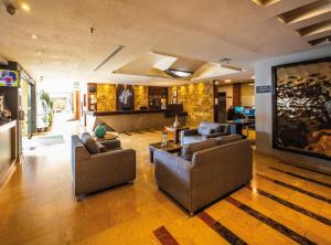 a living room with two couches and a tv at Holiday Inn Orizaba by IHG in Orizaba