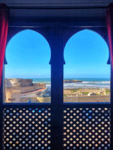 a view of the ocean from a window at Ocean Hideaway - Sea View in Essaouira +36 photos