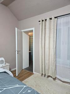 a bedroom with a bed and a door to a bathroom at 2-room apartment with attached bathroom No Kitchen in Gelsenkirchen