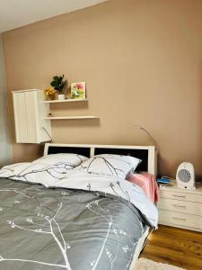 a bedroom with a bed with a white headboard at 2-room apartment with attached bathroom No Kitchen in Gelsenkirchen