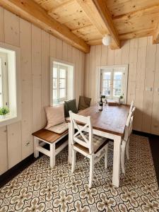 a dining room with a wooden table and chairs at Chalupa Andělka in Josefŭv Dŭl