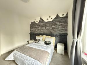 a bedroom with a bed and a brick wall at Verdellino Bijoux Residence in Verdellino +26 photos