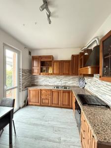 a kitchen with wooden cabinets and a brick wall at Verdellino Bijoux Residence in Verdellino