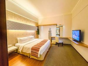 Ένα ή περισσότερα κρεβάτια σε δωμάτιο στο De Palma Hotel Ampang