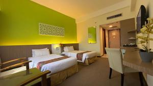 Ένα ή περισσότερα κρεβάτια σε δωμάτιο στο De Palma Hotel Ampang