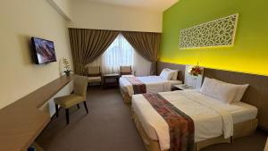 Ένα ή περισσότερα κρεβάτια σε δωμάτιο στο De Palma Hotel Ampang