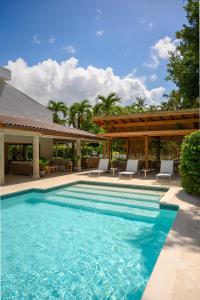 a swimming pool with chairs and a house at New! Gorgeous Portillo Beach Villa W Pool & Staff in Abra Grande