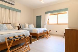 a bedroom with two beds and a window at New! Gorgeous Portillo Beach Villa W Pool & Staff in Abra Grande +33 photos