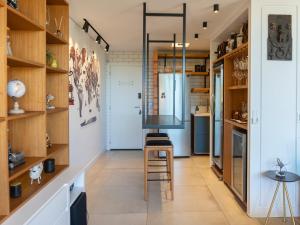a kitchen with wooden shelves and a stool in a room at luxstudiocampeche in Florianópolis