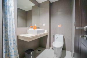 a small bathroom with a toilet and a sink at THE CABIN APARTMENT PATRALAND AMARTA in Kejayan +8 photos